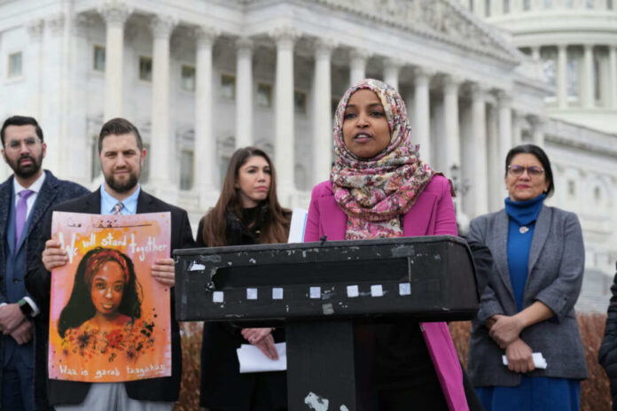 ilhan-omar-speaks2254713577jpg Speaker at outdoor press event with group standing near government building