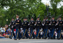 Mount Rushmore Becomes Trump’s Stage Soldiers in dress uniforms march in formation during a parade
