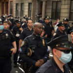 Defund Backfire: Top NYC Lib Folds Group of uniformed police officers standing on a city street