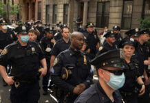 Group of uniformed police officers standing on a city street