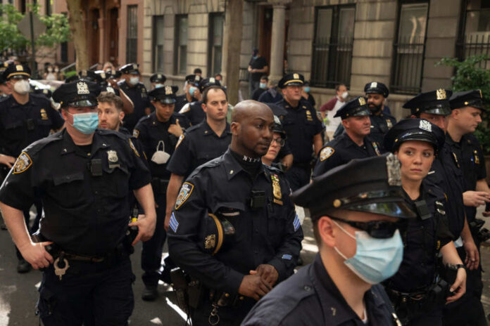 new-york-city-police-officers1754871284jpg Group of uniformed police officers standing on a city street