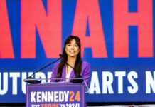 Endorsement Claim BLOWS UP In Florida Woman in purple blazer speaking at a podium on stage