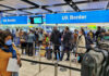 Travelers queue at UK border control in an airport