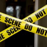 Homicide Detectives Swarm Mattapan Rental Yellow crime scene tape crossing a doorway