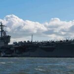 Aircraft carrier at sea with fighter jets on deck