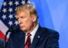 6,000 Hopes Crushed—Trump’s Quiet Clemency Purge man at podium speaking into microphone
