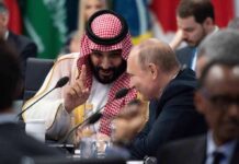 Hormuz Deal: Tiny Patch, Huge Stakes Two delegates converse at an international summit table