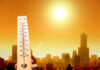 Heatwave Carnage Stuns Germany Thermometer displaying high temperature against a sunset city skyline