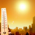 Heatwave Carnage Stuns Germany Thermometer displaying high temperature against a sunset city skyline
