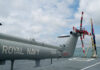 Military helicopter on a naval deck with a cloudy sky