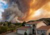 Firestorm Hits Madrid’s Doorsteps Suburban house under towering wildfire smoke plume
