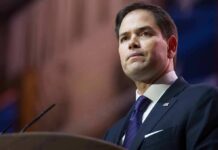 Rubio’s Terror Flip Sparks Global Uproar man in suit speaking at podium