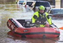 Rescue worker in an inflatable boat during urban flooding