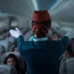 ICE Snags Flight Attendant Mid-Shift Flight attendant giving safety demonstration in airplane aisle