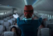 ICE Snags Flight Attendant Mid-Shift Flight attendant giving safety demonstration in airplane aisle