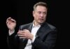 Deficit Brawl Explodes: Musk vs. Trumpworld man in a suit speaking with hand gestures