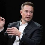 man in a suit speaking with hand gestures