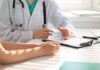 Deadly Cancer Hides In Plain Sight Doctor discusses medical notes with patient at a desk