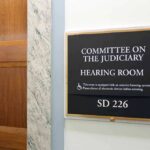 Committee on the Judiciary hearing room sign on wall