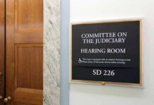 Immigration Hearing Turns Racial Firestorm Committee on the Judiciary hearing room sign on wall