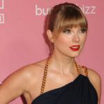 Swift Wedding? NYC Bends Rules Quietly Woman with bangs in black dress on pink backdrop