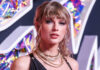 Woman with bangs wearing layered necklaces, colorful background.