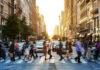 Map Snub Ignites Little Italy Fury People crossing a busy city street at sunset