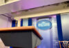 Empty podium in White House press briefing room.