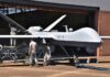 Iran’s Trophy Parade Masks A Bigger Play Military drone being serviced by ground crew outside a hangar