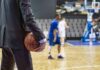 WNBA Rule Chaos Sparks Explosive Standoff Basketball coach in suit holding ball courtside