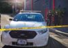 Kansas Showdown Over Mass Tracking Police car behind yellow caution tape on a city street