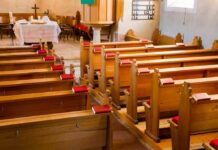 HIV Scandal Engulfs Florida Pastor Empty wooden church pews with red hymnals