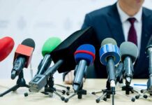 Fifth Amendment Bombshell Torches Fauci’s Legacy microphones clustered on a table at a press conference