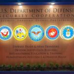 Judge FREEZES Pentagon Blacklist Move U.S. Department of Defense display wall with service seals