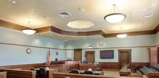 Empty courtroom with wooden benches and judge's bench