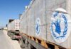 Humanitarian aid trucks loaded with palletized supplies