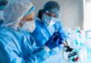 AOC’s Bold Move Sparks Fertility Firestorm Scientists in protective gear working with a syringe in a laboratory