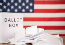 Ninth Circuit Carves Up Arizona Voting Laws Ballot box with papers in front of an American flag