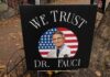 Contempt Drama Looms After Fauci Silence yard sign with portrait of a doctor over a U.S. flag