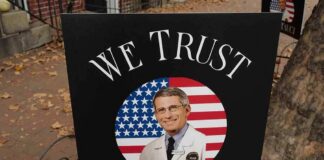 yard sign with portrait of a doctor over a U.S. flag