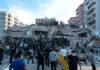 Rescue workers and civilians on collapsed building after earthquake