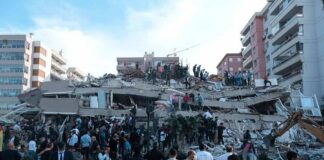 Rescue workers and civilians on collapsed building after earthquake