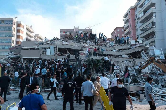 Rescue workers and civilians on collapsed building after earthquake