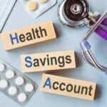 Health savings account blocks with stethoscope and pills