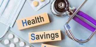 Health savings account blocks with stethoscope and pills