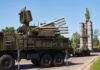military air defense vehicles on a road
