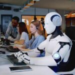 AI Layoffs Spike — But Not Where Expected Robot and office workers at computers in a modern workspace