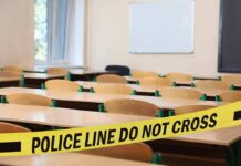 Empty classroom with police tape across desks