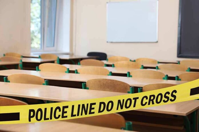 shutterstock_2344759813-9 Empty classroom with police tape across desks