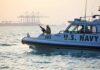 U.S. Navy patrol boat with armed crew on the water